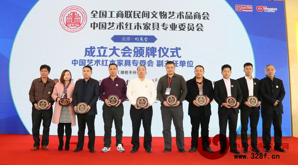 名典红木董事长朱永德（右三）上台接受全联艺术红木家具专委会副主任单位颁牌