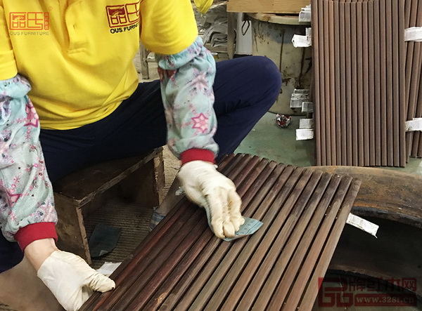  区氏臻品工人对交椅进行反复打磨，直至表面平整光洁